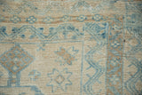 Hand-knotted texture of a distressed Turkish rug with even wear and geometric guls in blue and platinum.