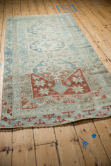 Heavy dye lot change on a vintage Anatolian rug from copper-red starbursts to a muted sky blue field.