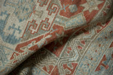 Close-up showing the low, even pile and hand-knotted texture of a distressed Turkish rug.