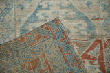 Hand-knotted construction and machine-bound edge of a vintage distressed Anatolian rug corner.