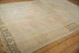 Soft, blanket-like texture of a distressed Oushak carpet showing low pile and color abrashes.