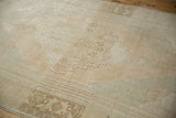 Soft, distressed texture of a vintage Oushak with heavy, time-softened color abrashes.