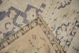 Distressed vintage Taspinar rug, showing ivory pile, faded blue pattern, and tightly woven back.