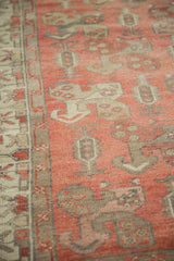 Distressed Oushak rug: blush field with softened boteh motifs and light colored border.