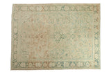 Distressed vintage Turkish Isparta carpet, ivory field with pale green floral medallion and palmettes.