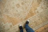 Distressed Oushak carpet with faded decorative patterns and mostly even low pile wear.