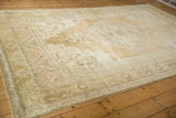 Corner detail of distressed vintage Oushak rug, showing even wear and blue-green border accents.
