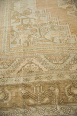 Distressed vintage Oushak pile, showing mostly even wear to knot heads and motifs.
