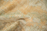 Soft, evenly worn pile of a distressed Oushak rug in sandalwood and seafoam green.