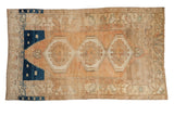 Distressed vintage Oushak rug with faded peach field, geometric medallions, and deep indigo blue, 4'4