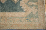 Distressed vintage Isparta pile showing faded indigo and coffee brown geometric motifs.