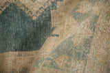 Distressed texture of a vintage Isparta rug, with dusty indigo blue and pale brown pile.