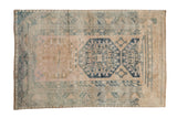 Vintage hand-knotted Anatolian rug with distressed beige, pale pink, and dusty blue octagonal guls, 3'6