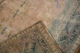Distressed Anatolian rug pile with beige, pink, blue tones, revealing its patterned woven back.