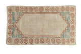 Distressed Oushak rug with an ivory lozenge medallion, light blue corner spandrels, and a copper floral border.