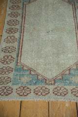 Textural wear to knot heads on the stepped corner spandrel of an Oushak rug.