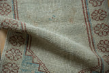 Evenly worn pile of a distressed Oushak rug, revealing the hand-knotted texture and foundation.