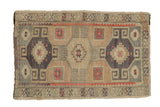 Distressed vintage Kars rug with a triple medallion design in sand, dusty blue, and muted red accents.