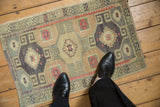 Vintage distressed Kars rug mat with a geometric medallion design, shown to scale.