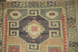 Detail of a pomegranate medallion and ram's horn designs on a hand-knotted Turkish Kars mat.