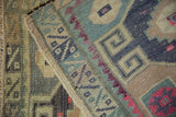 Corner detail showing the hand-knotted low pile and intact side cord selvage of a vintage Kars rug.