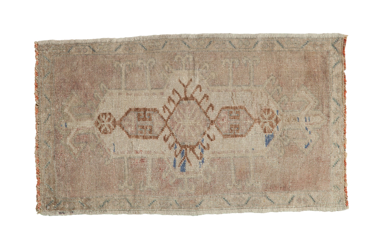 Distressed Oushak rug mat with ivory and coffee brown cartouche medallion, subtle hook and latch motifs.