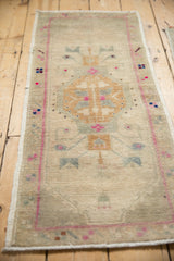 Soft pile of vintage Oushak rug, showing hexagonal medallion, floral motifs, and pearl dots.