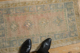 Distressed Oushak mat pile showing even wear, faint foundation, and faded blush, blue, gold.