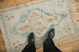 Overhead view showing the scale of a small distressed Turkish Oushak rug.