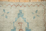 Distressed Oushak rug pile showing even wear across the knot heads with sky blue geometric details.