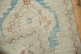 Reverse side of a distressed Oushak rug showing hand-knotted construction and weave.