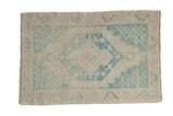 Distressed Oushak rug with a hexagonal center medallion in sky blue on a worn ivory and platinum field.