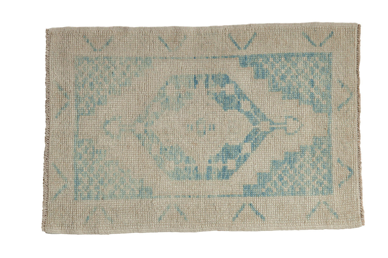 Distressed Oushak rug with a hexagonal center medallion in sky blue on a worn ivory and platinum field.
