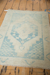Angled view showing the low, even pile and hand-knotted texture of a distressed Oushak rug.