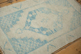 Even wear across the knot heads of a distressed Turkish Oushak rug in ivory and blue.