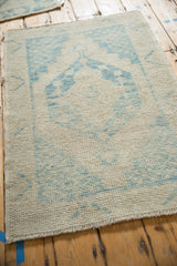 Evenly worn pile on a distressed Oushak rug with the faint foundation visible.