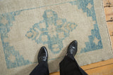 Even wear across knot heads on a distressed Oushak rug in ivory and sky blue.