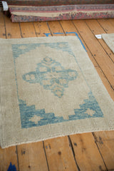 The even wear and blue stepped spandrel on the corner of a distressed Turkish Oushak rug.