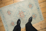 Overhead view showing the scale of a distressed Oushak rug with geometric starburst patterns.