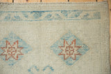 Evenly worn, textured knot heads on a distressed Oushak rug with blue and copper motifs.