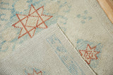 A close-up of the hand-knotted foundation and reverse weave of a distressed Turkish Oushak rug.