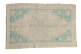 Distressed Oushak rug features faded sky blue stepped medallion on an ivory field, 2'5