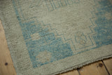 Distressed Oushak rug's side selvage and worn pile with platinum and powder blue tones.