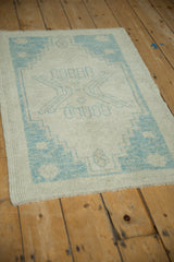 Distressed vintage Oushak rug corner detail, highlighting powder blue geometric motifs.