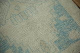 Texture detail of distressed Oushak rug pile, with platinum and sky blue stepped motifs.