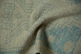 Decorative distressed Oushak rug texture, showing soft antique ivory and powder blue.