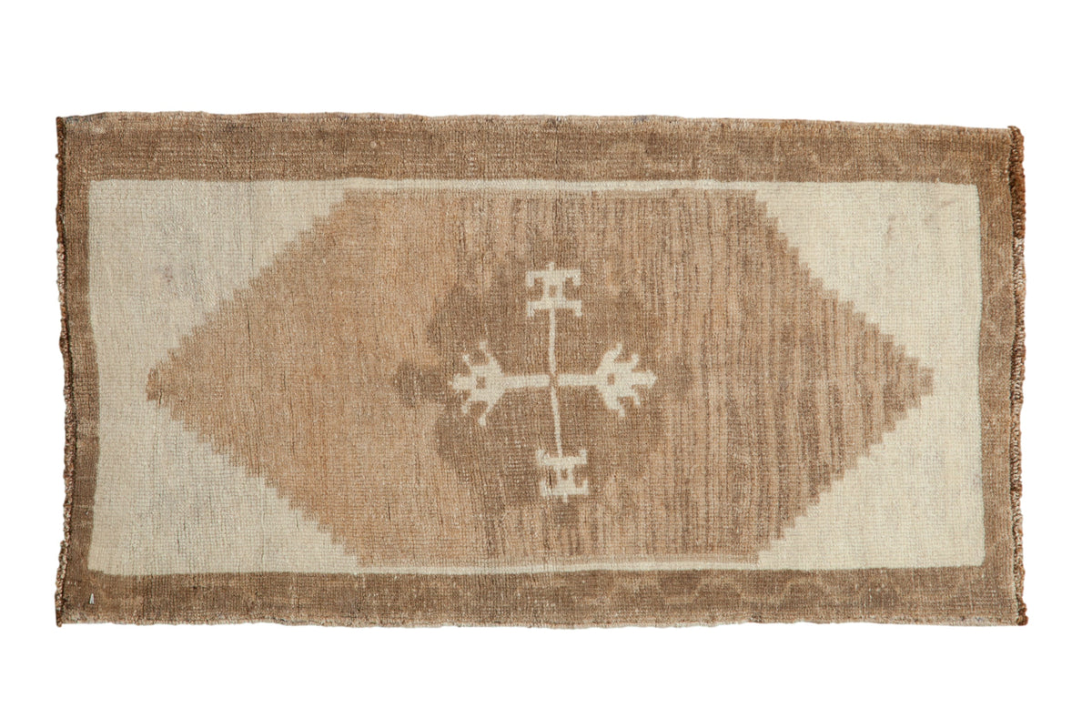 Distressed Kars rug with a central quatrefoil motif and stepped diamond in ivory and camel.