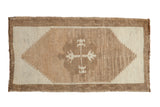 Distressed Kars rug with a central quatrefoil motif and stepped diamond in ivory and camel.