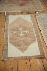Distressed Turkish Kars mat featuring a stepped geometric medallion in natural abrash tones.