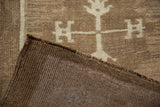 Hand-knotted coffee brown backing of the Kars rug, with ivory geometric pile.